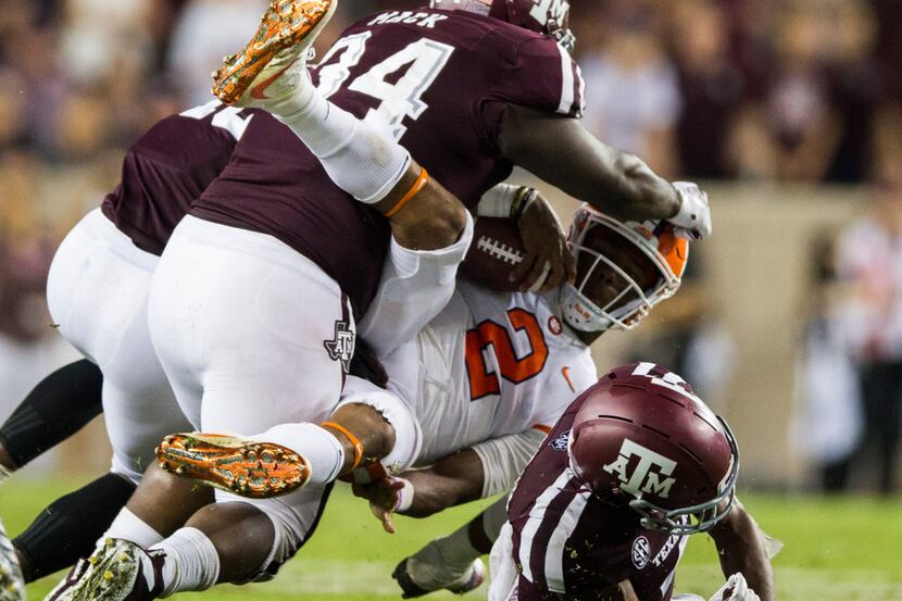 Clemson Tigers quarterback Kelly Bryant (2) is tackled by Texas A&M Aggies defensive lineman...