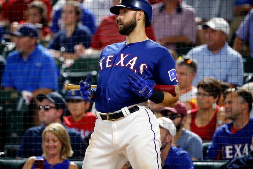 Texas Rangers batter Joey Gallo (13) stretches in the batting circle during the seventh...