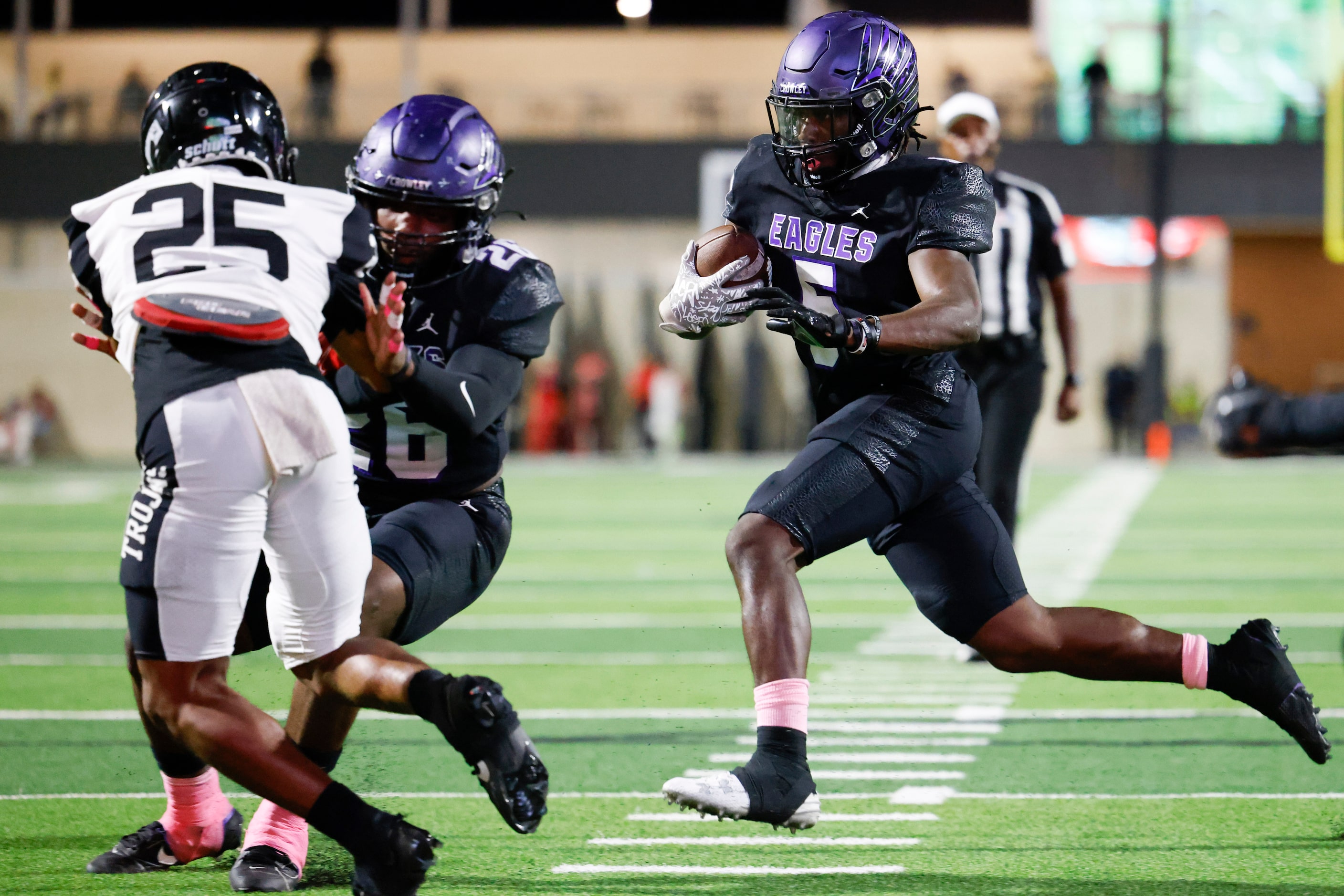 Crowley High’s Caleb Pope (right) runs to score a touchdown against Trinity High during the...