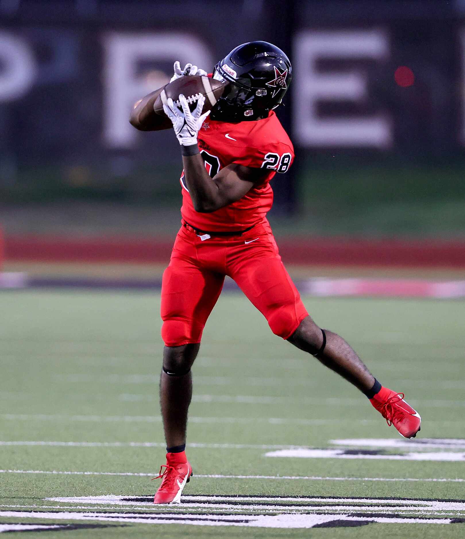 Coppell running back Xavier Mosely comes up with a reception against Lewisville during the...