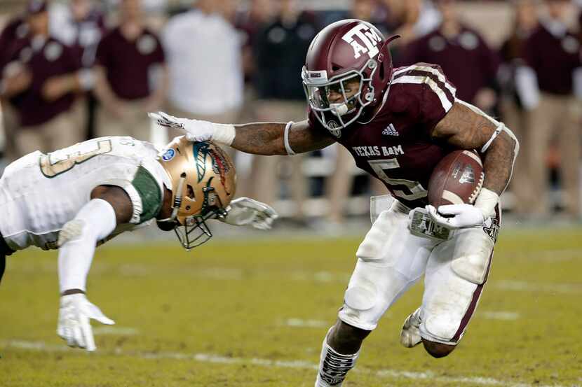 UAB safety Mar'Sean Diggs, left, dives to tackle Texas A&M running back Trayveon Williams...