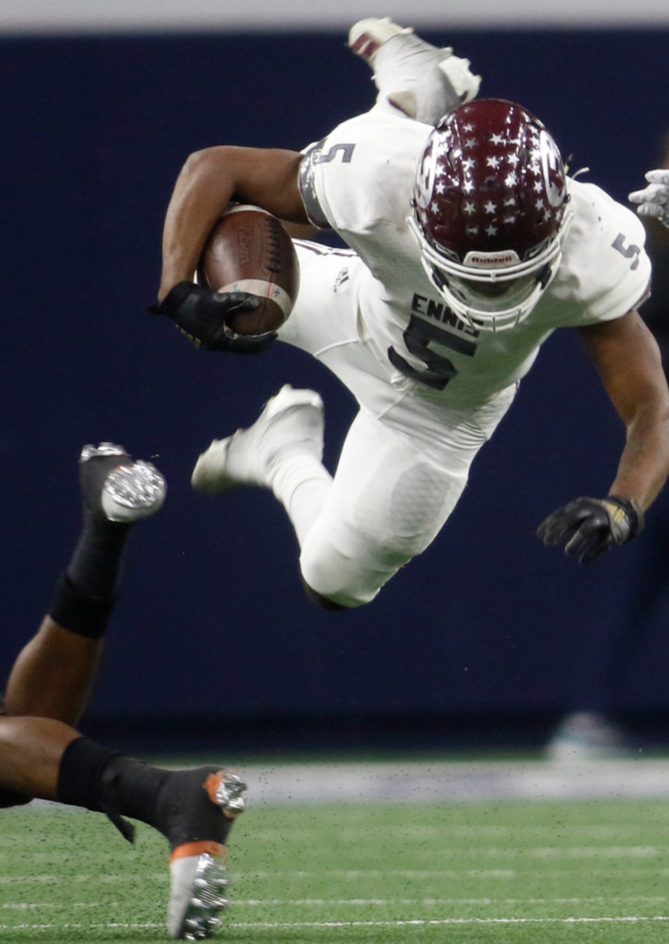 Ennis kick returner Stephon Townsend (5) is upended by an Aledo defender during a first half...