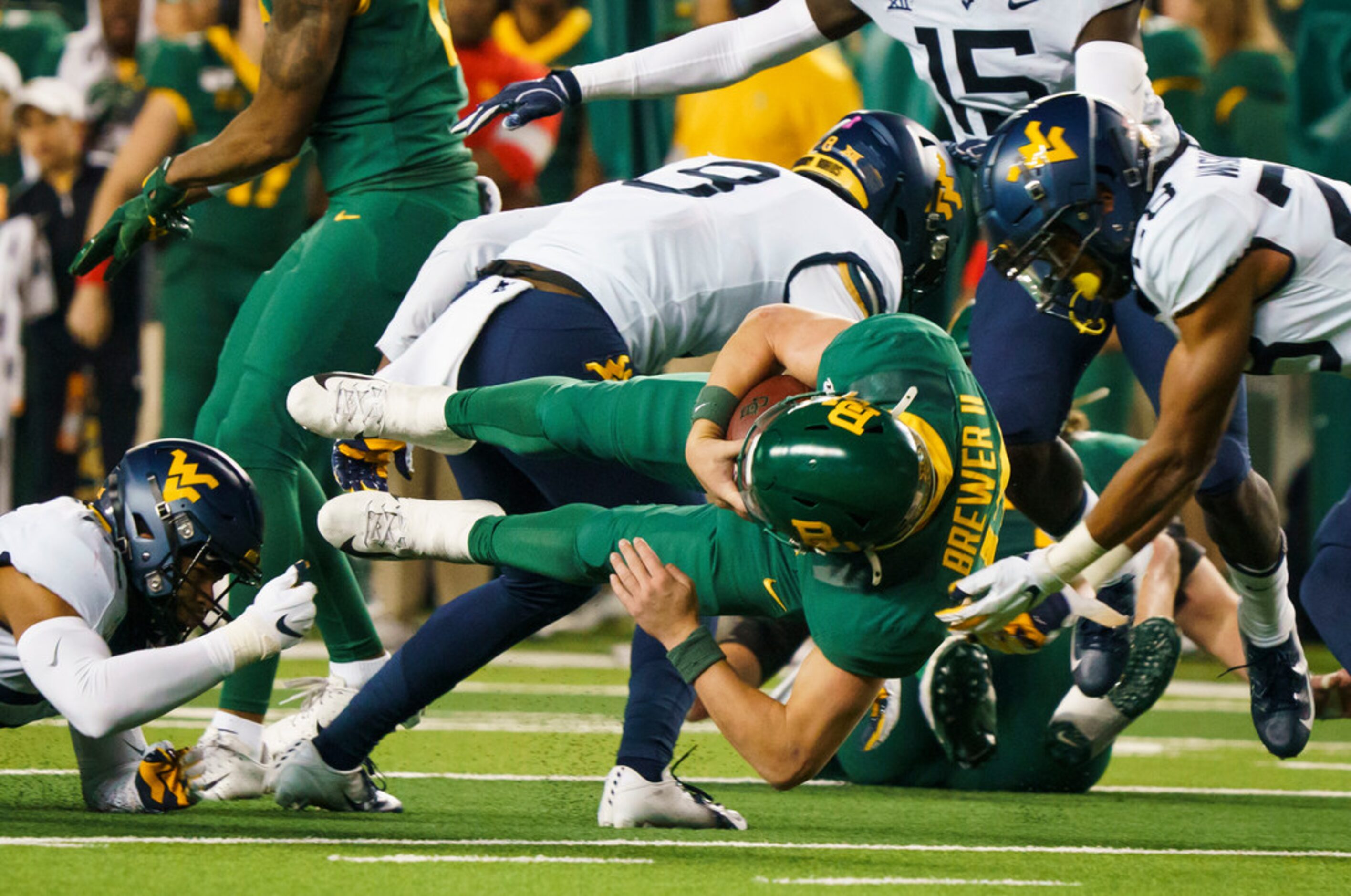 Baylor quarterback Charlie Brewer dives for extra yardage during the second half of an NCAA...