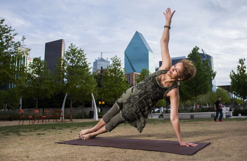Marie Gwyn does yoga at Klyde Warren Park. 