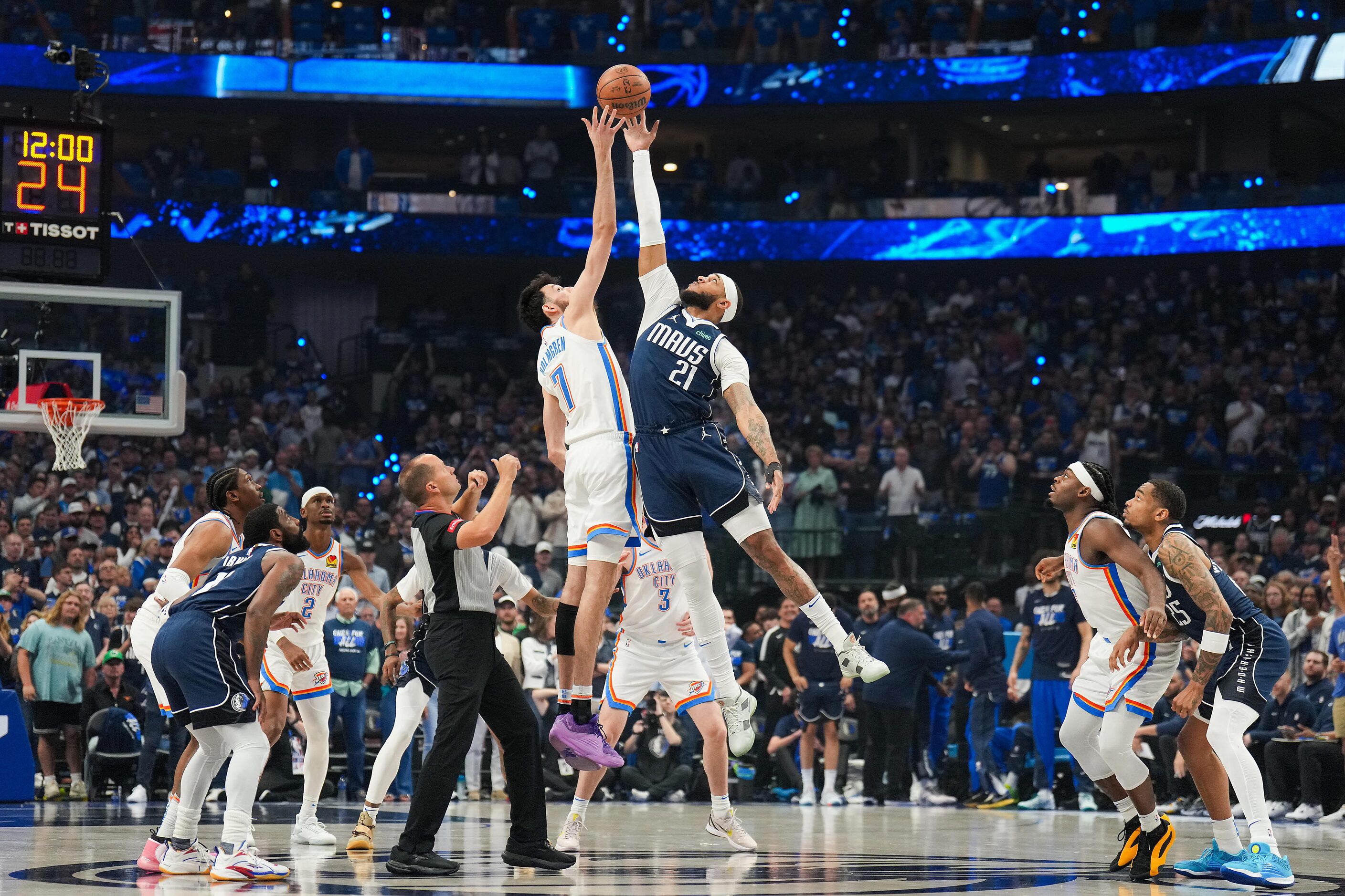 Dallas Mavericks center Daniel Gafford (21) goes up for the opening tipoff against Oklahoma...