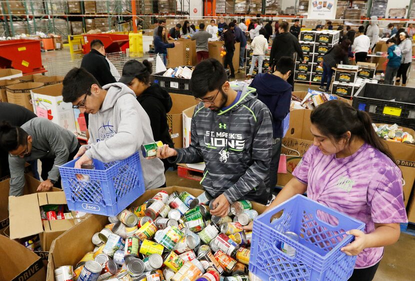 From left: Siblings Ozair Kamran, Daniyaal Kamran and Danees Kamran sorted food at the North...