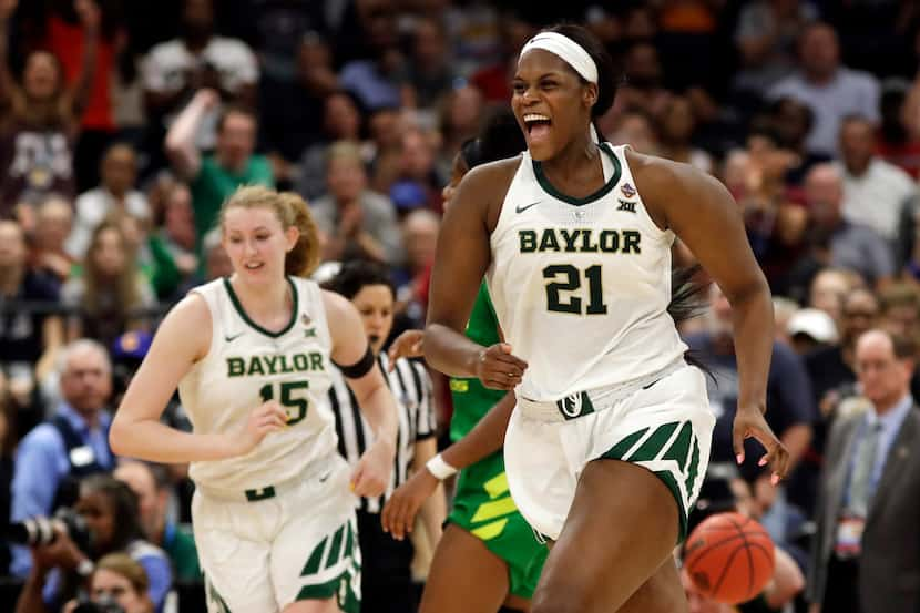 Baylor center Kalani Brown (21) and forward Lauren Cox (15) celebrate after defeating Oregon...