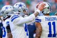 Dallas Cowboys quarterback Dak Prescott (4) talks with linebacker Micah Parsons (11) on the...