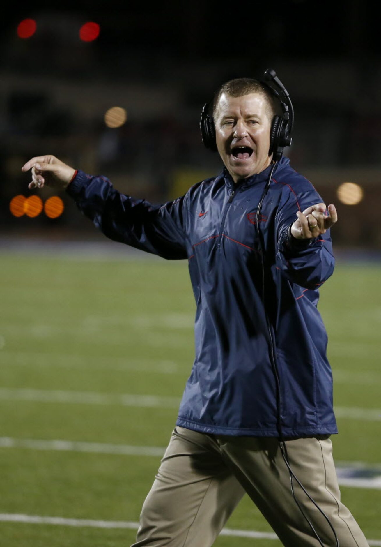 Allen's Head Coach Tom Westerberg directs his team against Plano East during the first half...