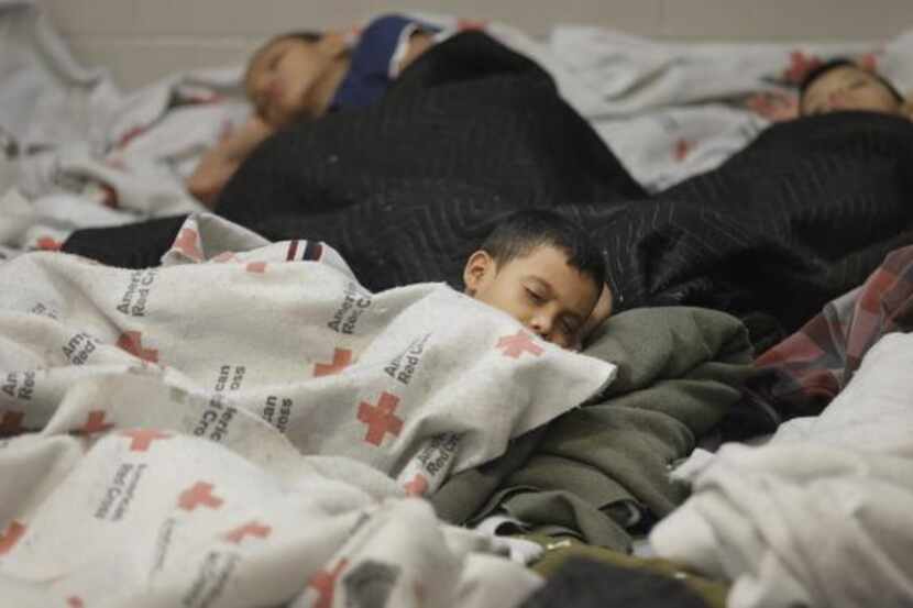 
Detainees sleep in a holding cell at a U.S. Customs and Border Protection processing...