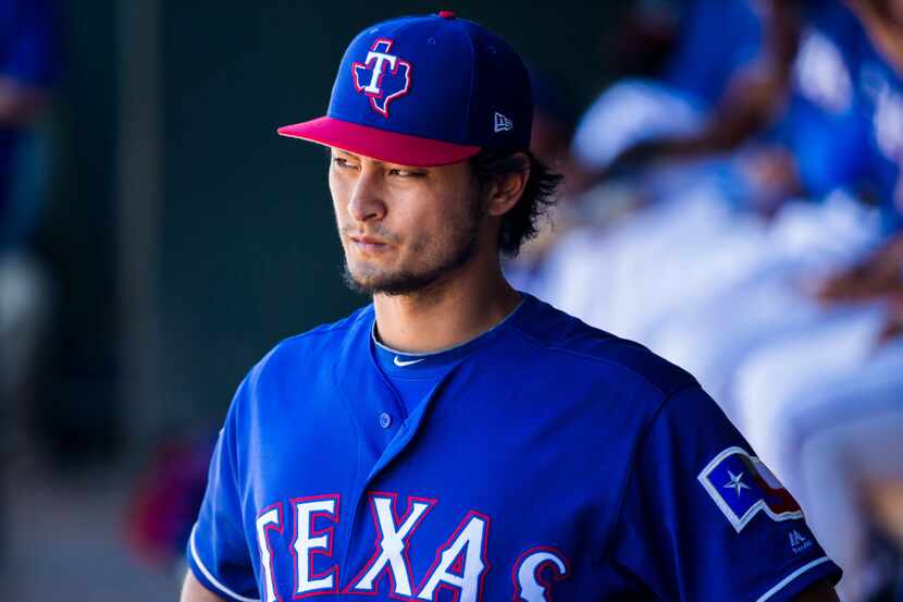 Texas Rangers starting pitcher Yu Darvish (11) watches from the dugout during the fourth...