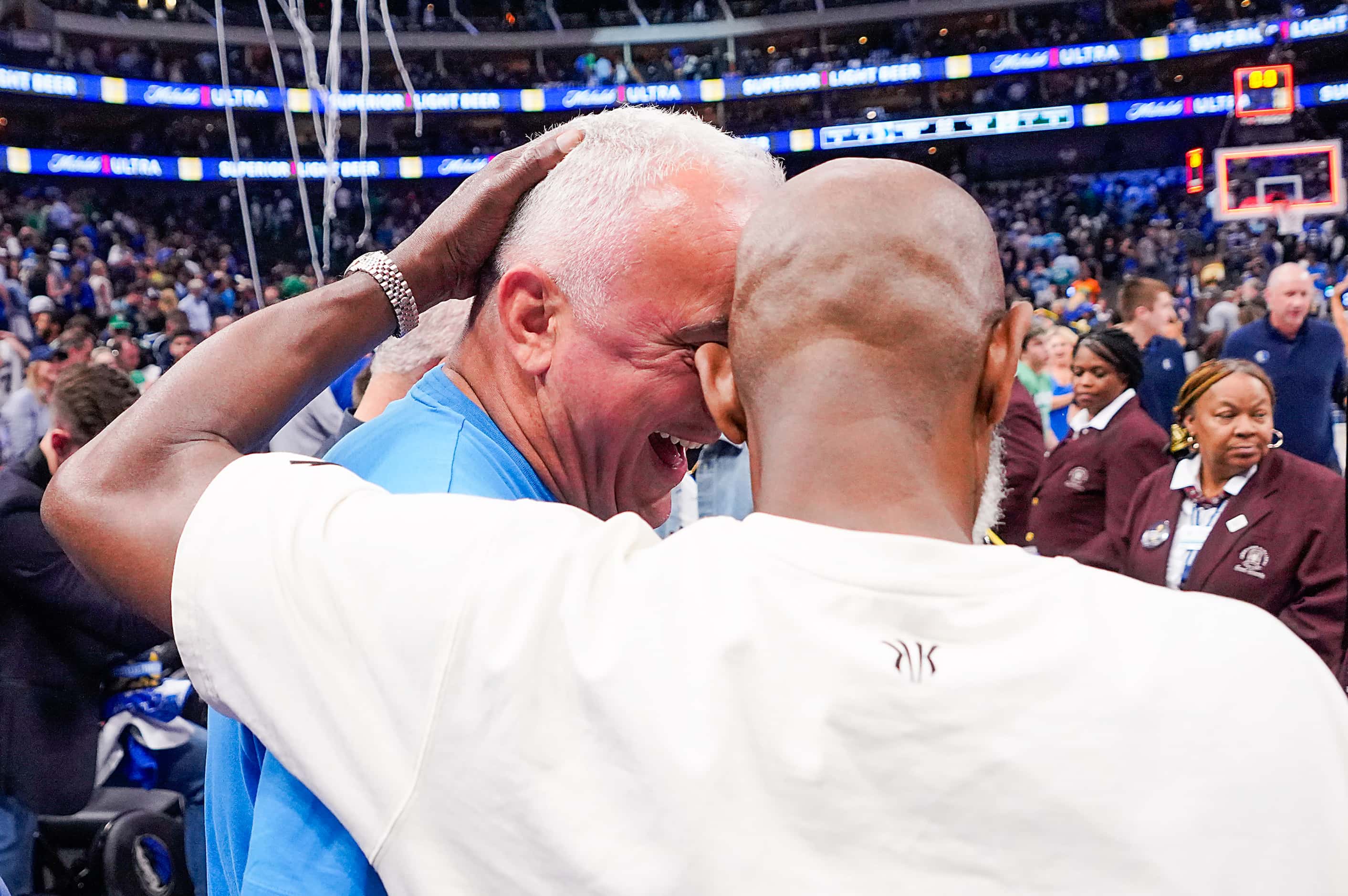 Dallas Mavericks guard Kyrie Irving’s father Drederick Irving (right) celebrates with Luka...