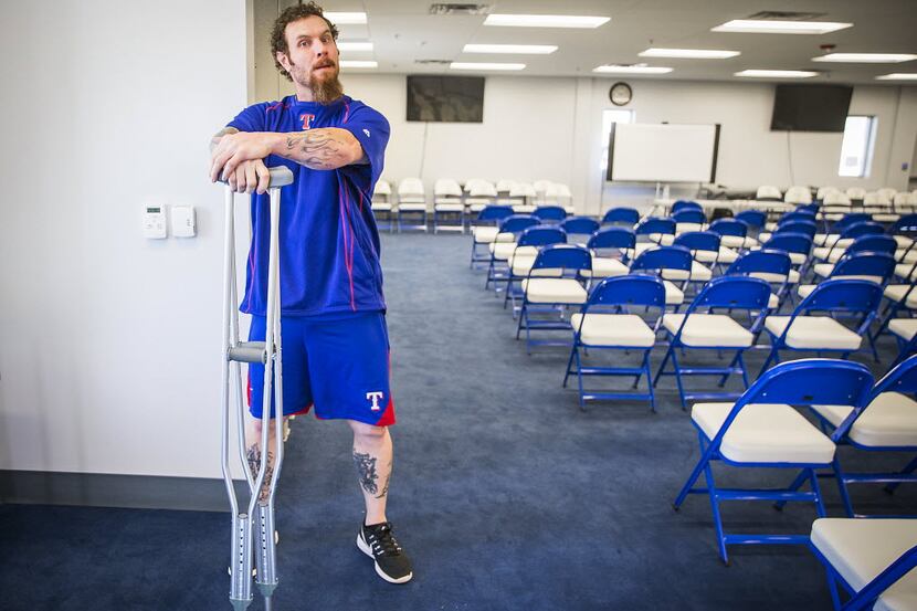 Texas Rangers outfielder Josh Hamilton leans on a pair of crutches before addressing the...