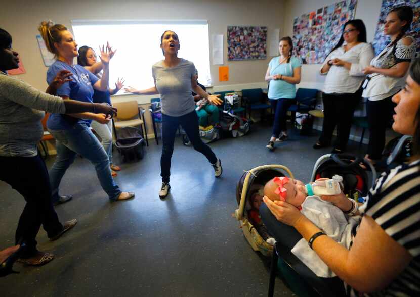 Jamie Lehew feeds her baby Lincoln (right) as Amber Bolanos (center) and her fellow mothers...