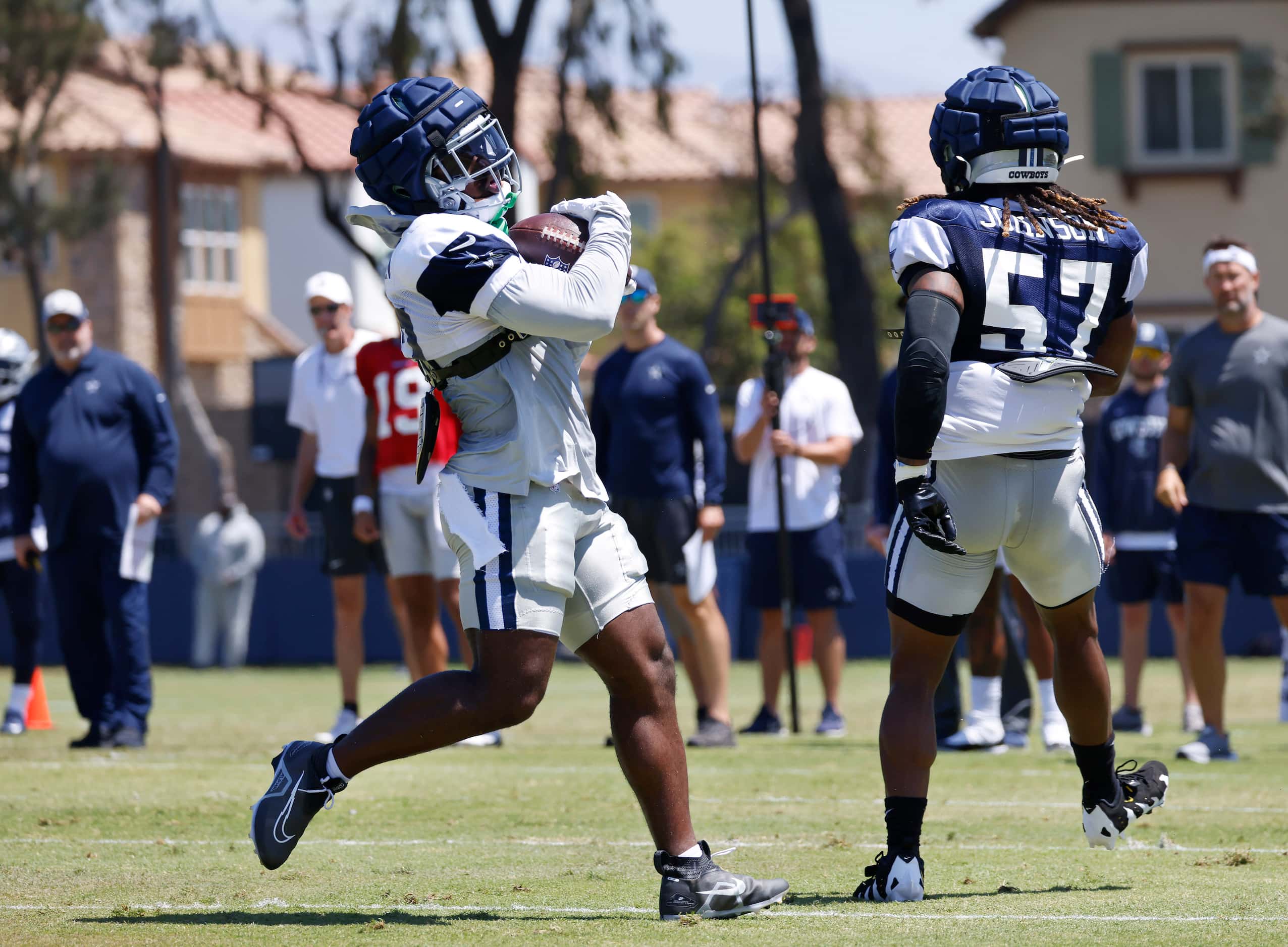 Dallas Cowboys running back Royce Freeman (27) catches a pass in front of linebacker Buddy...