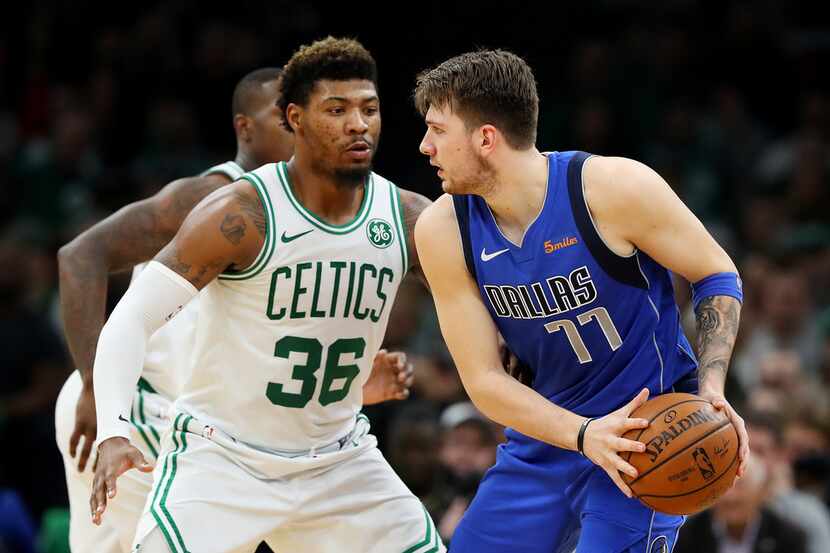 BOSTON, MASSACHUSETTS - JANUARY 04: Marcus Smart #36 of the Boston Celtics defends Luka...