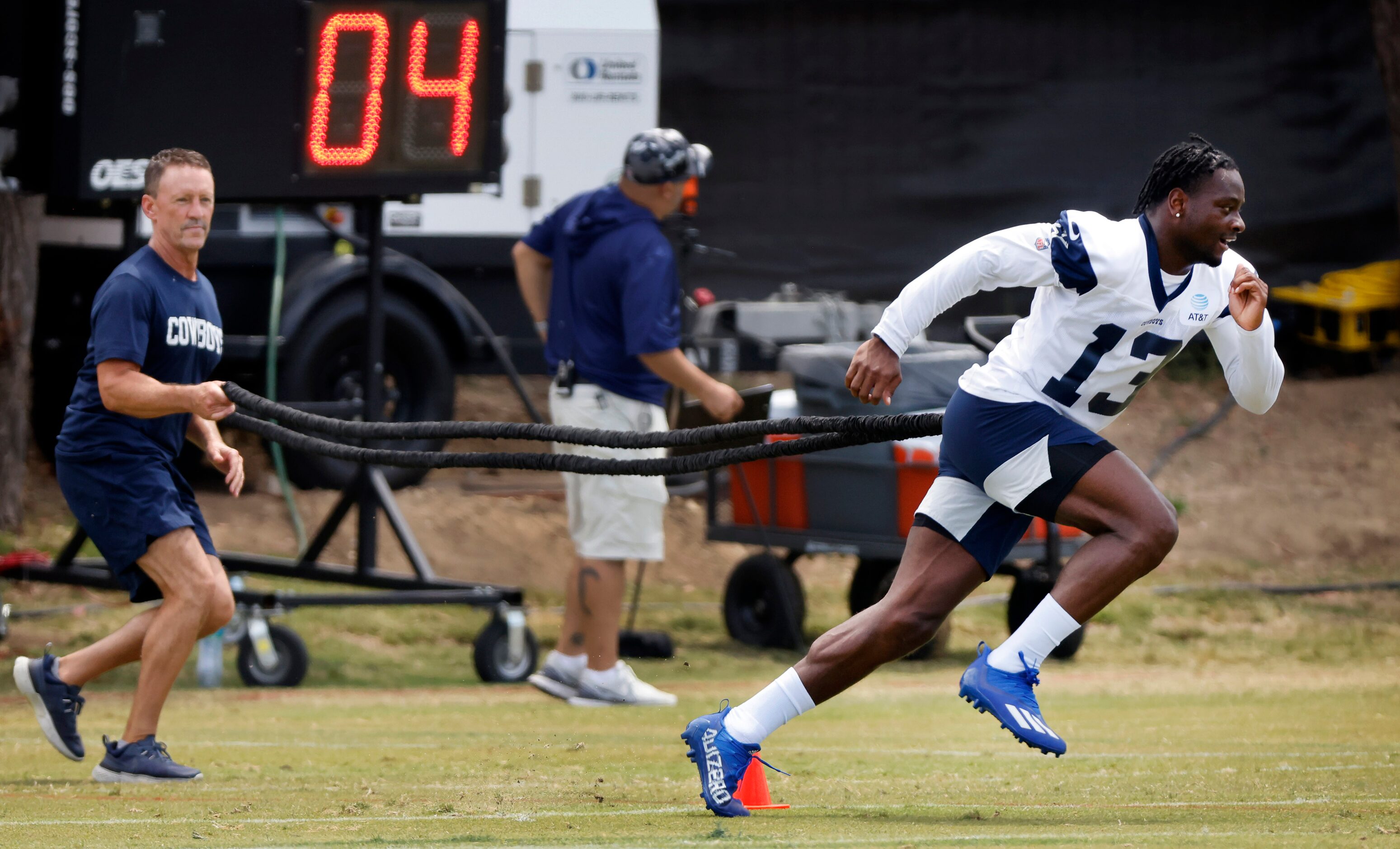 Dallas Cowboys wide receiver Michael Gallup (13) works with trainer Britt Brown (left) on a...