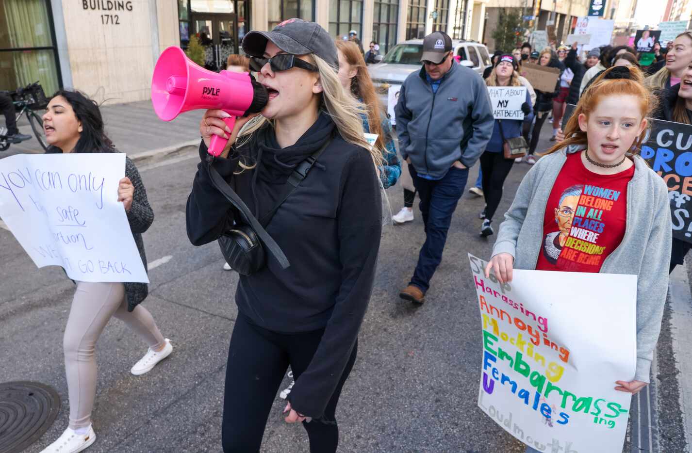 Jessi Couture (center) leads other Dallas activists in a chant as they march in downtown...
