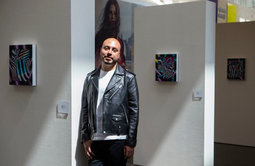 Artist Arthur Peña poses for a portrait alongside his artwork at NorthPark Center on...