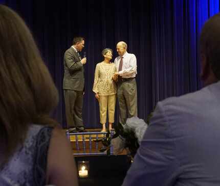 The Rev. Brent Ashby blesses Jim Spell and Pam Davidson at their wedding reception at...