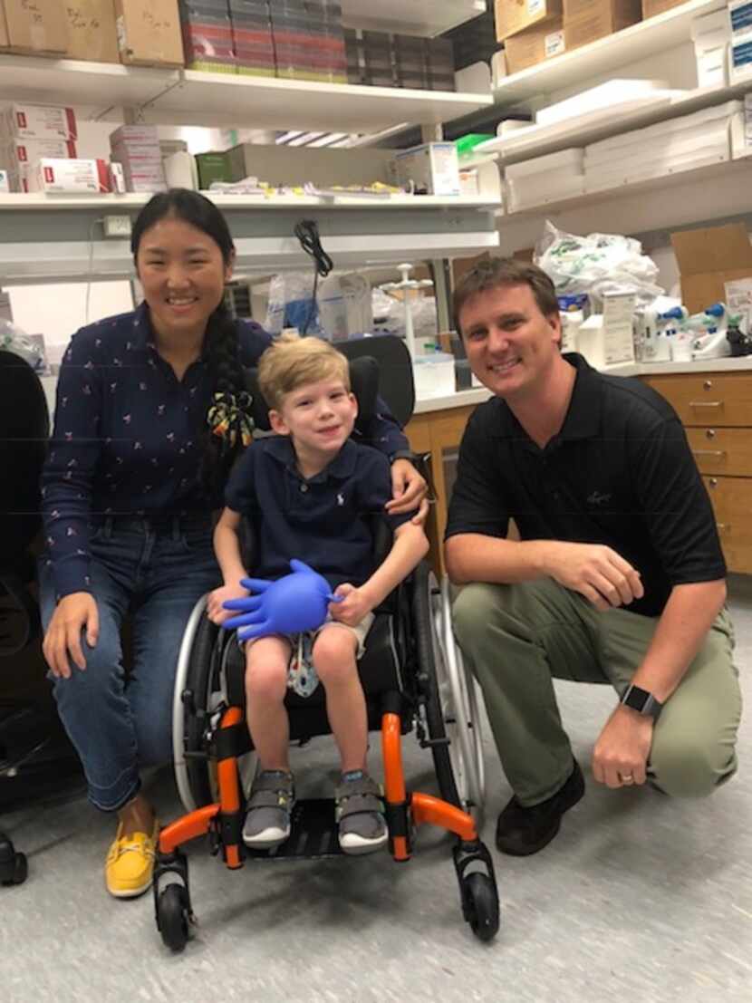 Will Woleben, 6, of McKinney, Texas visits with UT Southwestern Medical Center researchers...