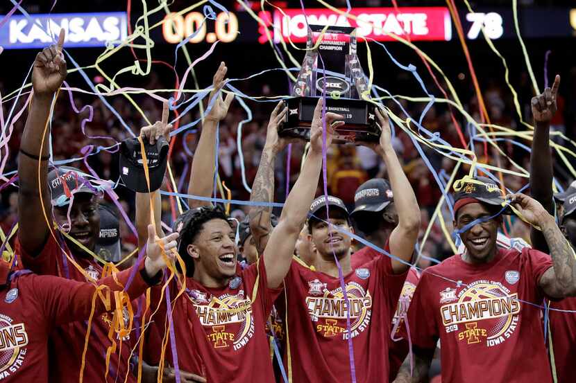 Iowa State players celebrate after defeating Kansas 78-66 in an NCAA college basketball game...