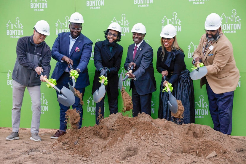 Bonton Farms staff and other representatives turn dirt during a ground breaking ceremony for...