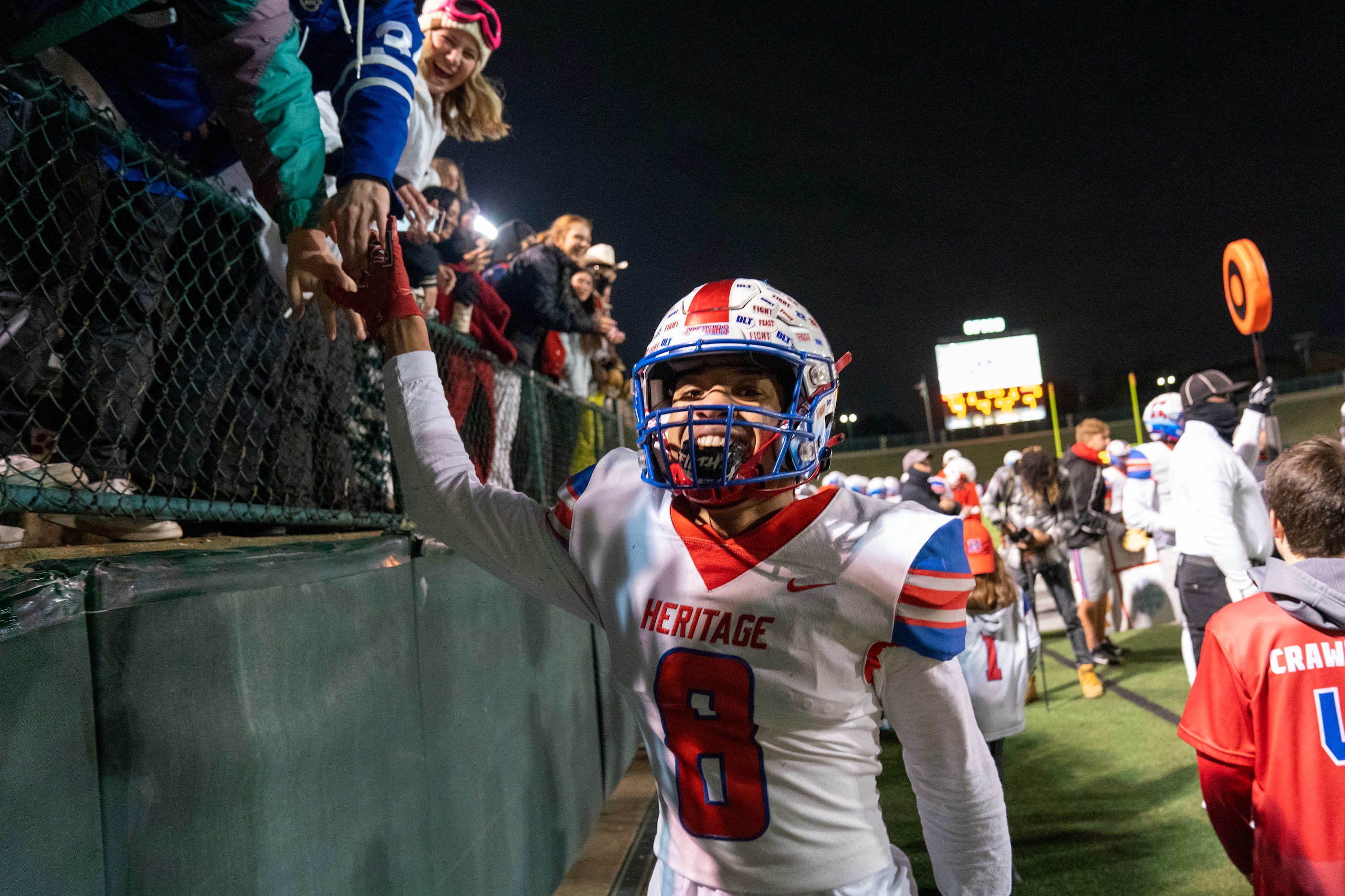 Midlothian Heritage senior defensive back Solomon Hopkins (8) celebrates with fans after...