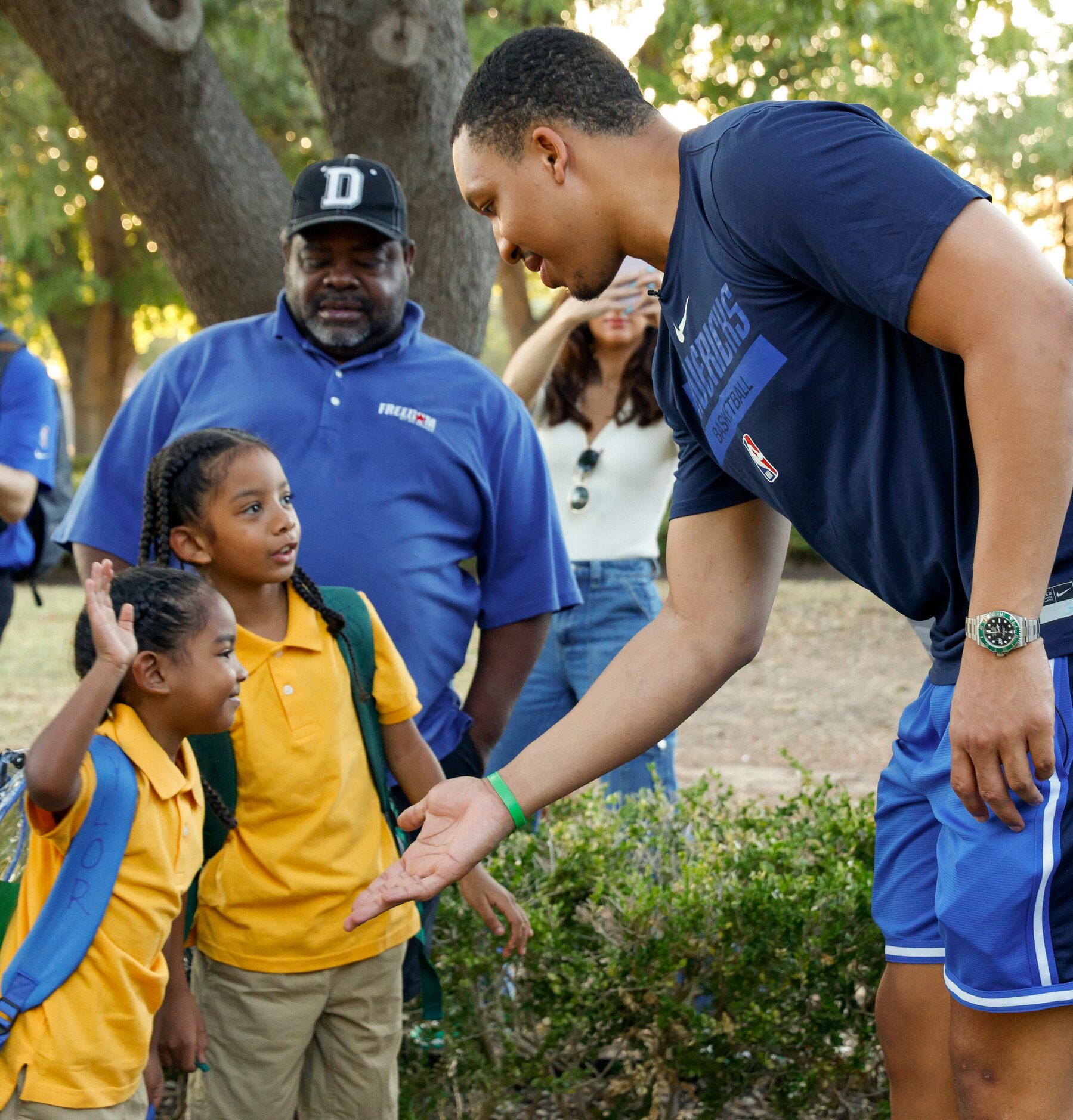 Taylor Sanft Oliver, 5 (right) high-fives Dallas Mavericks forward Grant Williams (right)...