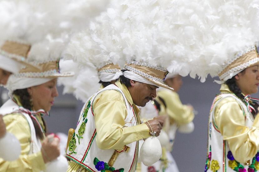 Juanito Gress, center, and his fellow performers dance in honor of the La Virgen De...