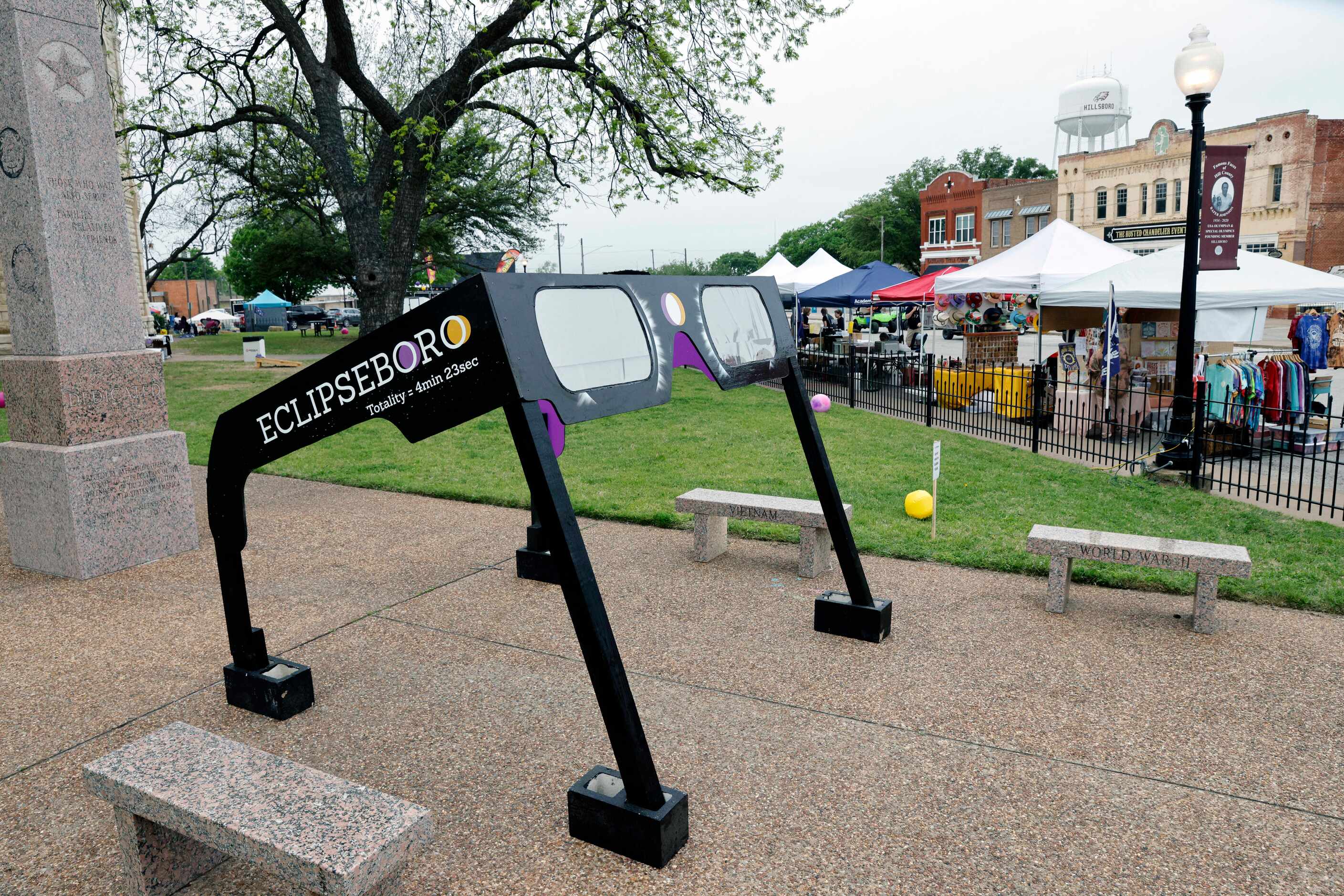 A pair of eclipse glasses sits outside the Hill County Courthouse as vendors set up their...