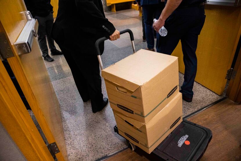 Detective Christine Ramirez carts boxes of evidence from Dallas Police Department’s...
