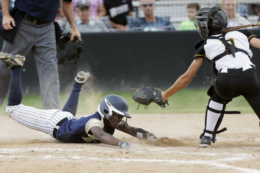 Plano East sophomore catcher Amy Jensen, right, is unable to make the tag as Keller junior...