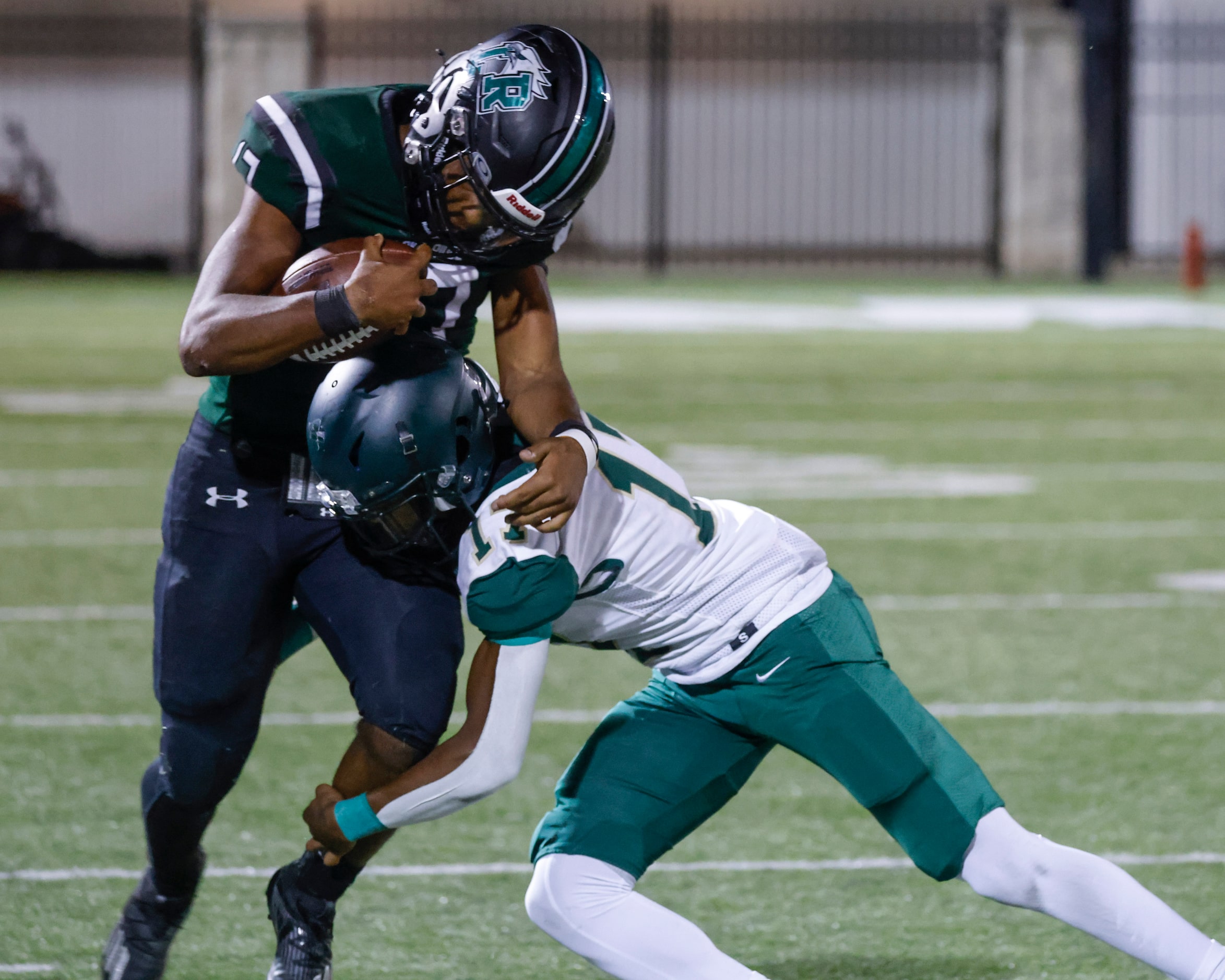 Lake Ridge High’s Kennen Miller (17), left, gets tackled by DeSoto’s Je’Shan McCoy (17)...