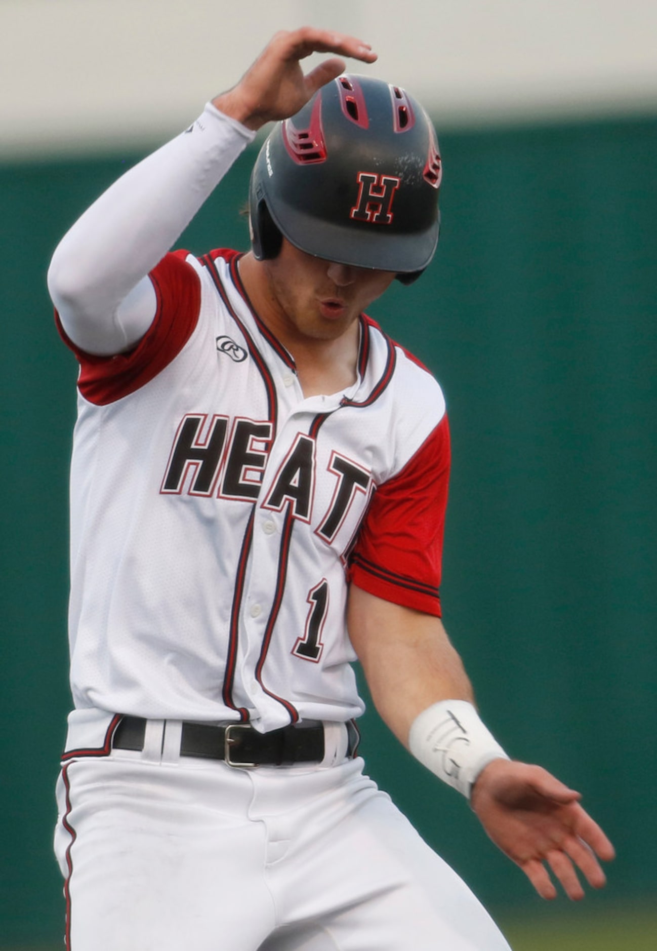 Rockwall Heath baserunner Casey Curtin (1) applies the brakes to avoid over running 3rd base...