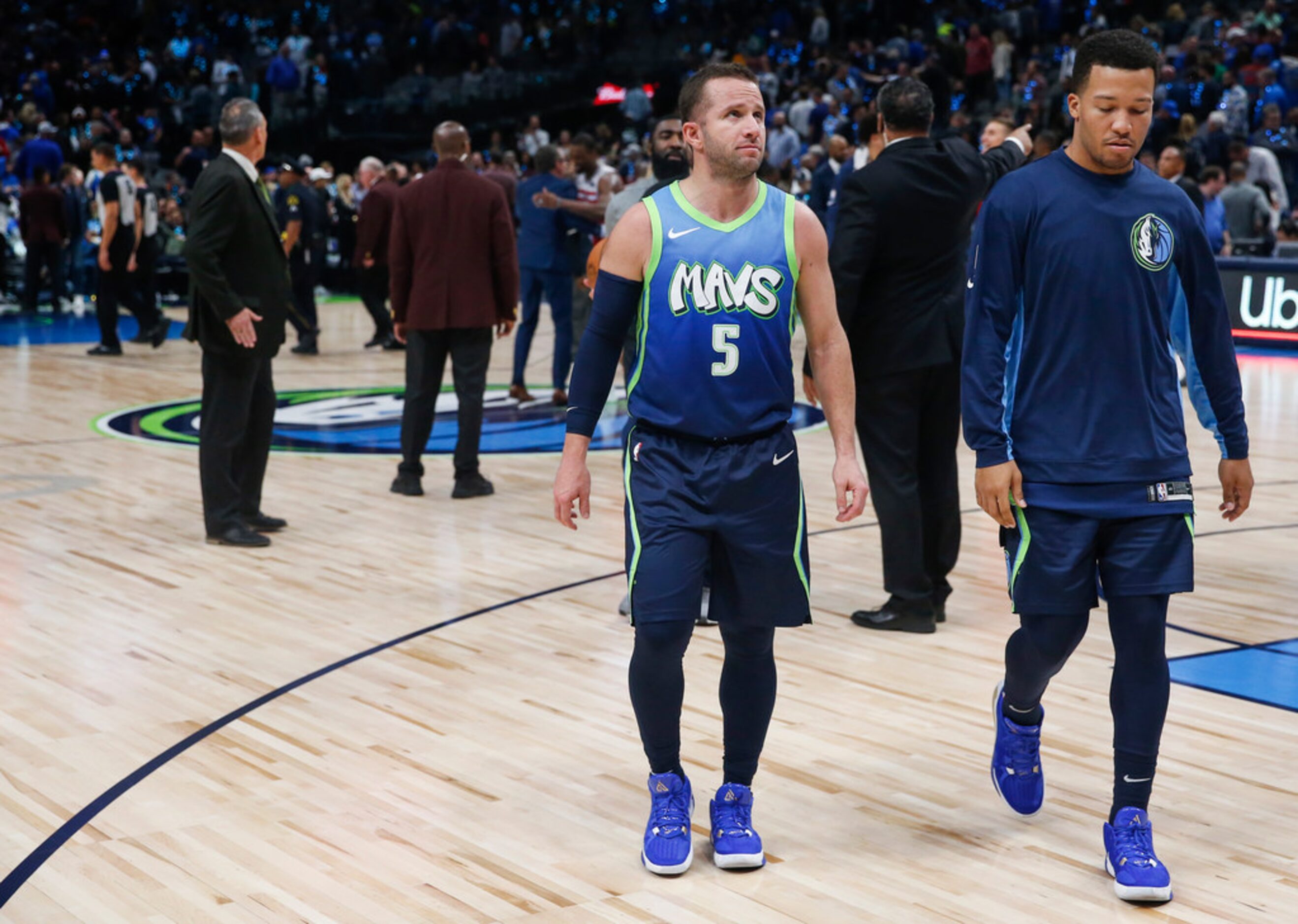 Dallas Mavericks guard J.J. Barea (5) and guard Jalen Brunson (13) exit the court following...