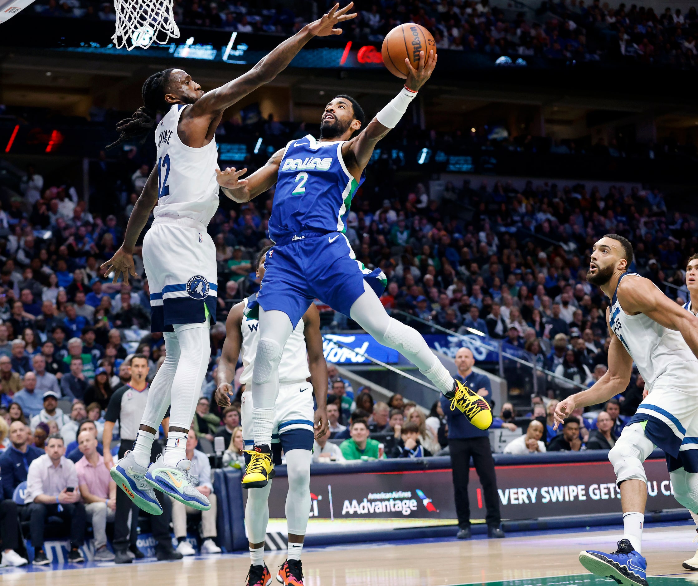 Dallas Mavericks guard Kyrie Irving (2) puts up a shot over Minnesota Timberwolves forward...