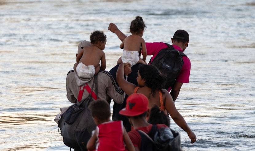 Migrants cross the Rio Grande into Eagle Pass, Texas as seen from Piedras Negras, Coahuila...