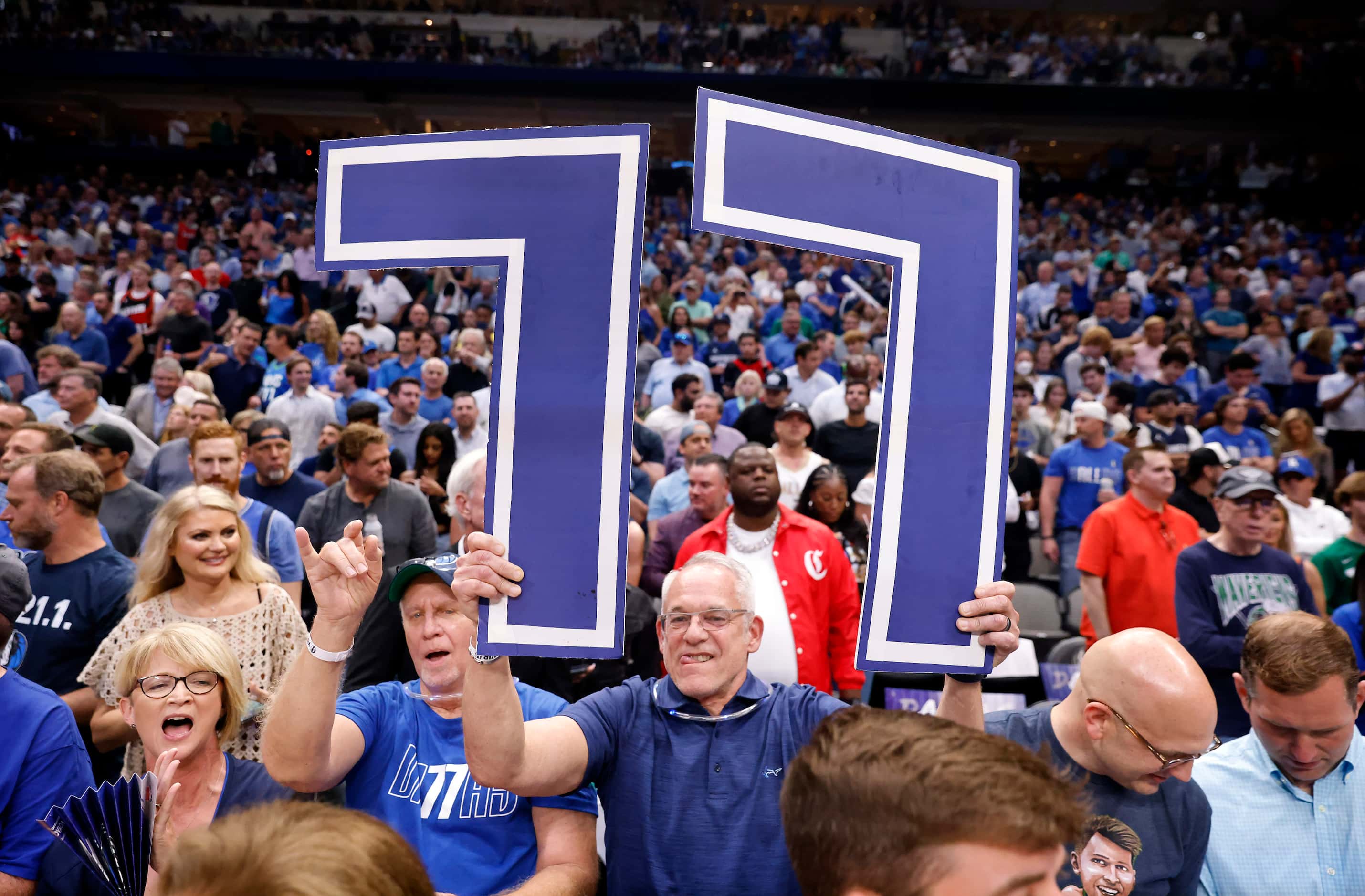 A Dallas Mavericks fan flashes Luka Doncic’s No. 77 as the teams are introduced before Game...
