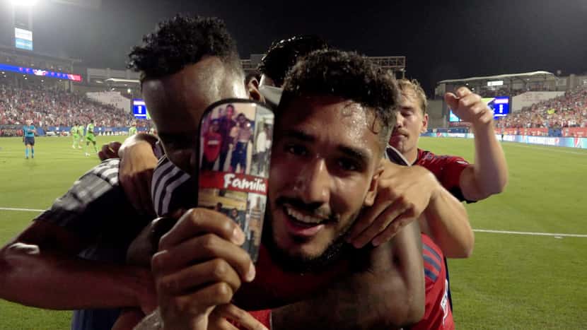 Jesus Ferreira shows off his shin pad with photos of his family.