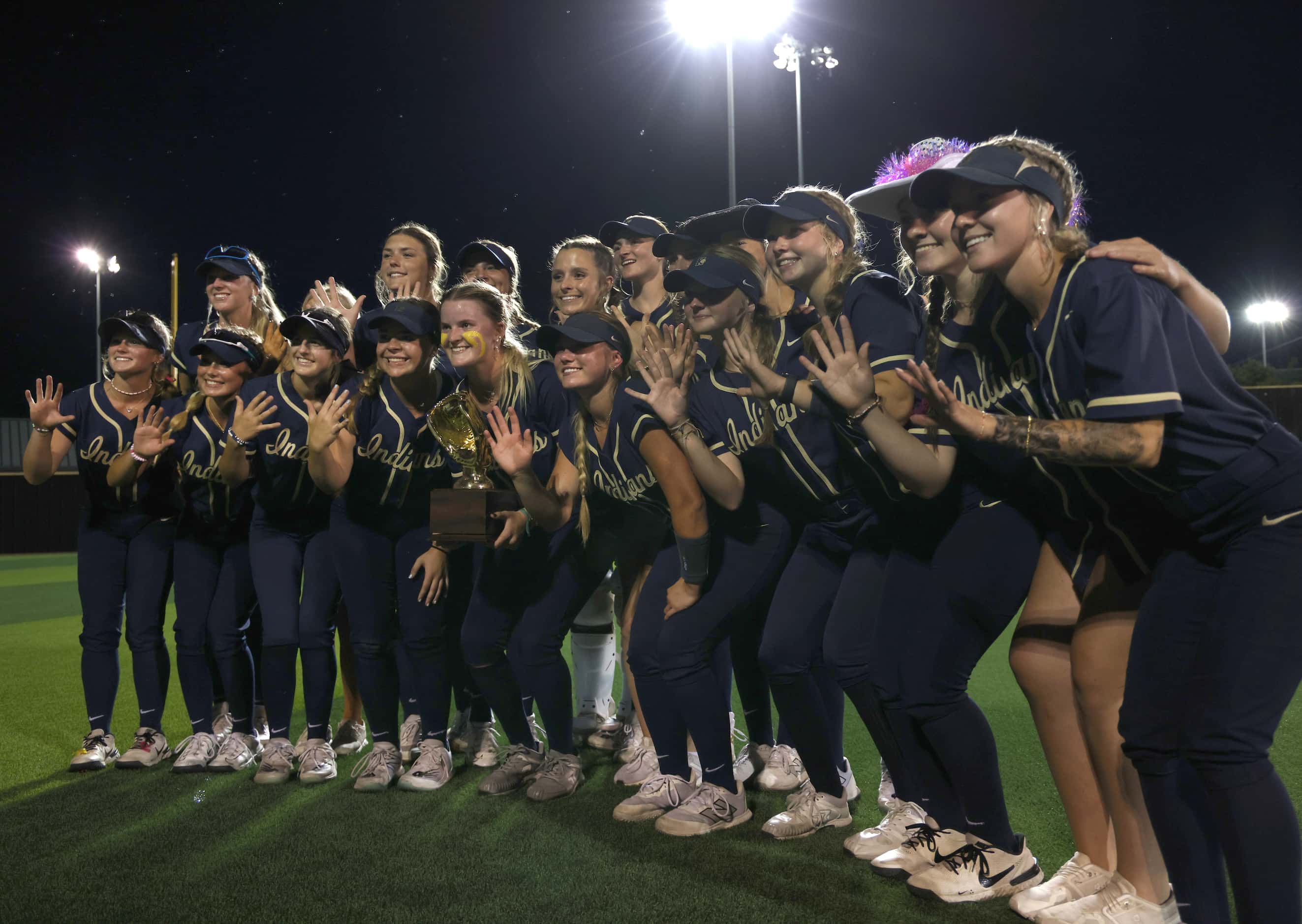 Keller players pose for a photo after their 10-0 victory over Plano West in 6 innings to...