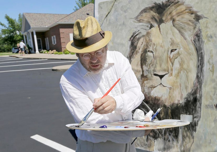 
Mark Balma worked on a mural of Cecil the lion outside Dr. Walter Palmer’s dental office in...