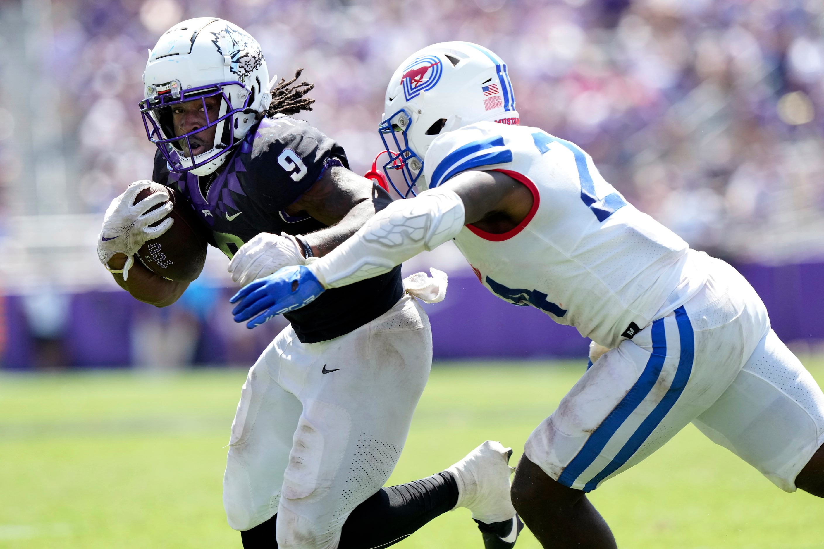 TCU running back Emani Bailey (9) runs against SMU linebacker Kobe Wilson (24) during the...