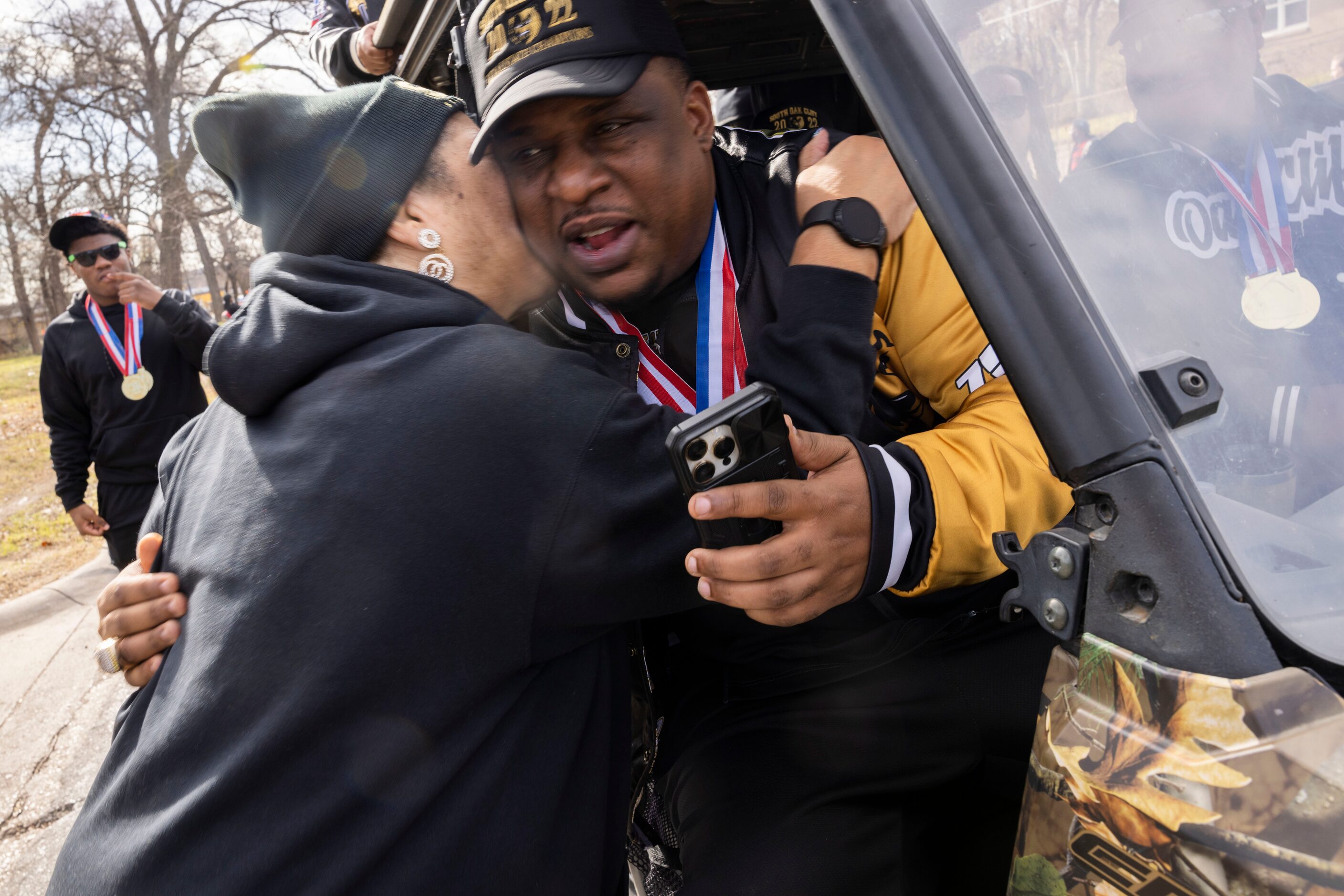 The South Oak Cliff Golden Bears coach Jason Todd receives a hug from SOC English teacher...