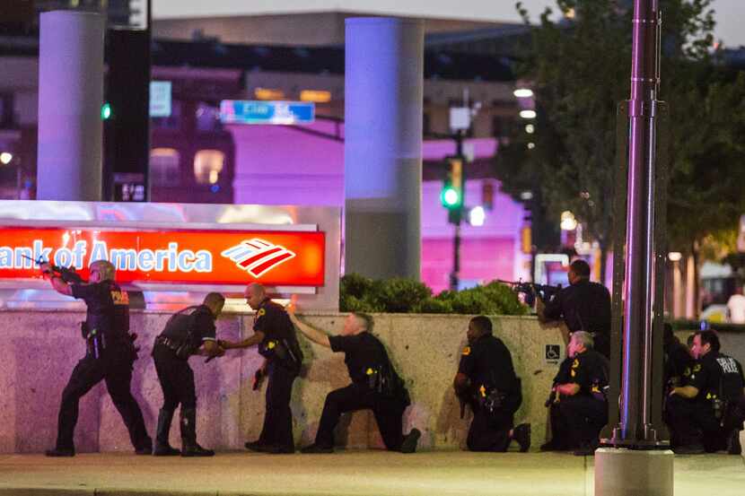 Police took cover behind a wall after coming under fire in the July 7 ambush in downtown...