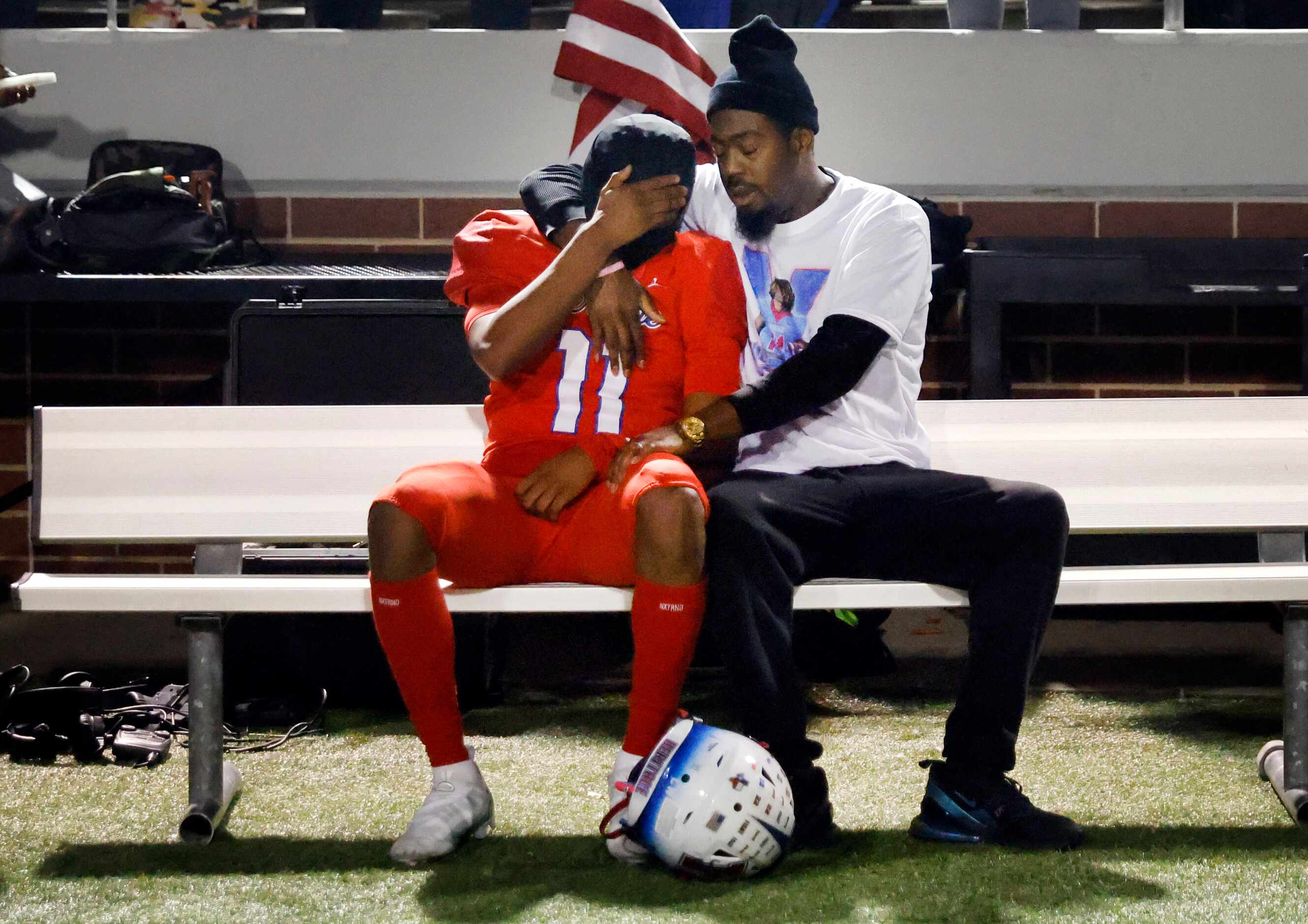 Midlothian Heritage receiver Xavier Moten (11) is comforted on the bench following their...