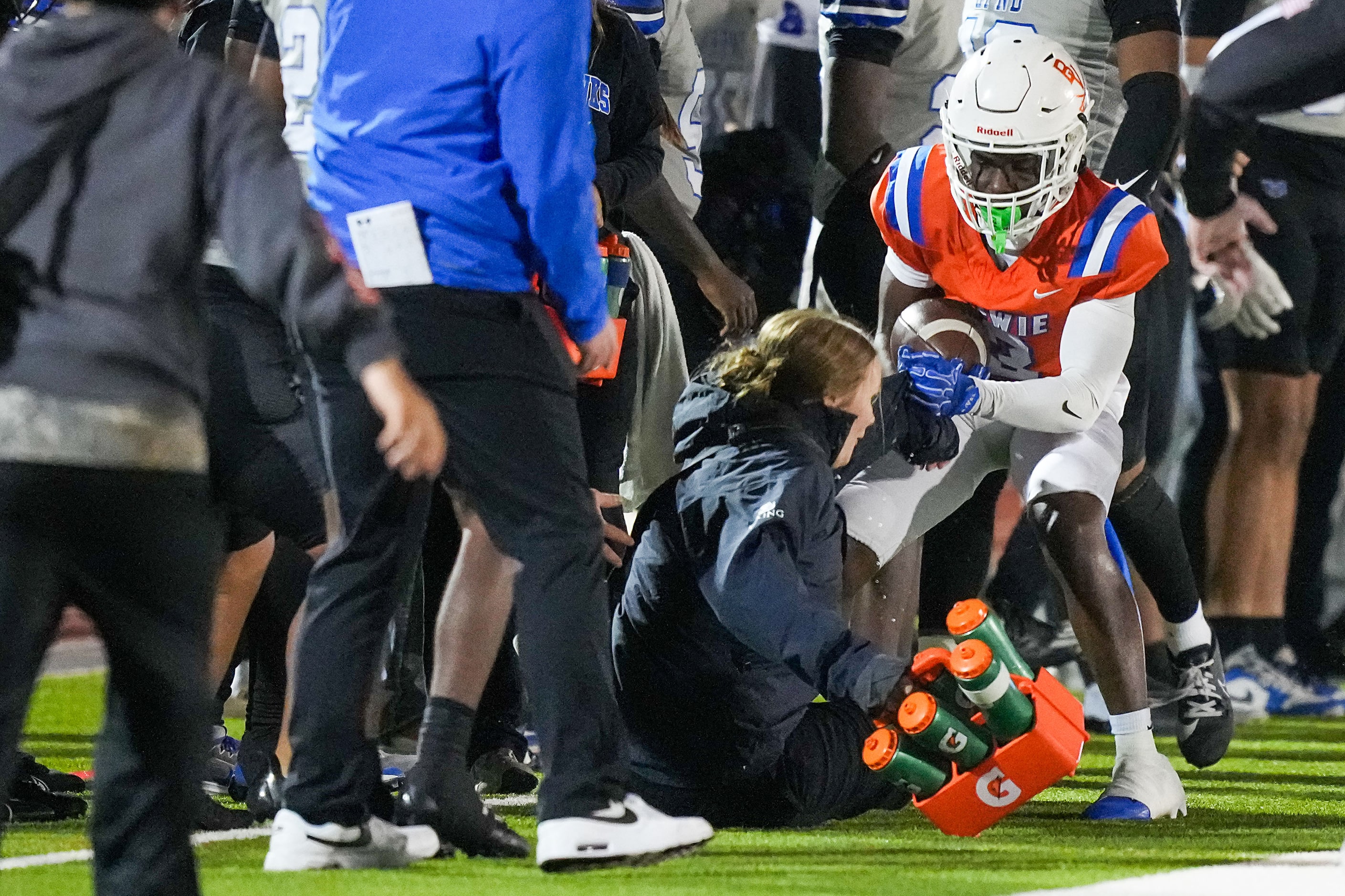 Arlington Bowie wide receiver Antonio Birdow (3) collides with a trainer as he is pushed...