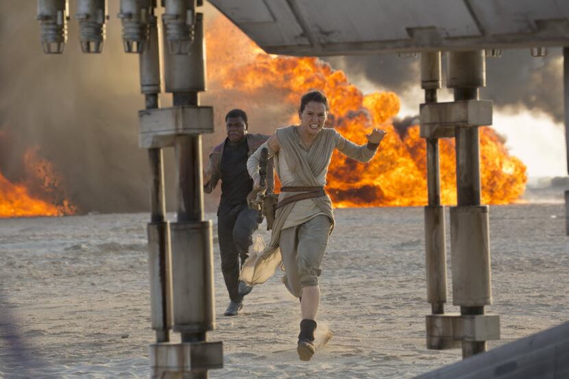 Daisy Ridley, right, as Rey, and John Boyega as Finn