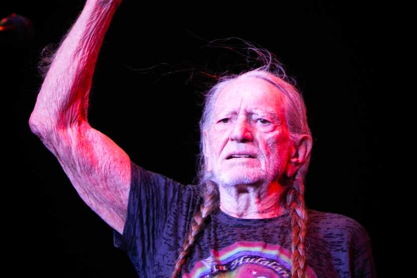 Willie Nelson greets the crowd during the Outlaw Music Festival at the Starplex Pavilion in...