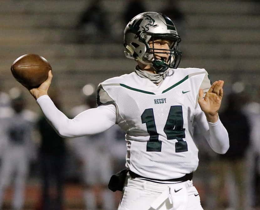 Reedy High School quarterback A.J. Padgett (14) throws on the teams first offensive play as...